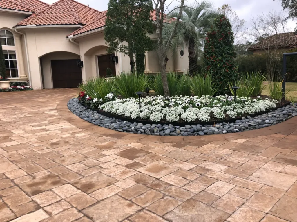 Paver driveway and professionally installed landscaping at a luxury home