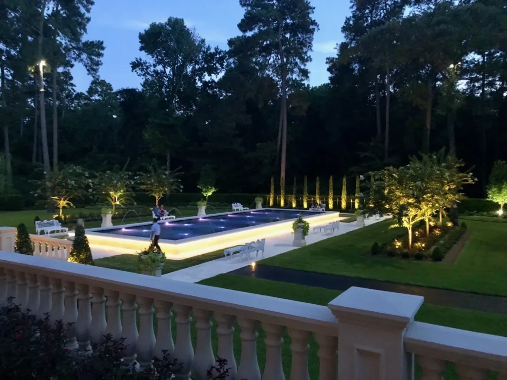 LED landscape lighting highlighting a high-end home and pool at dusk