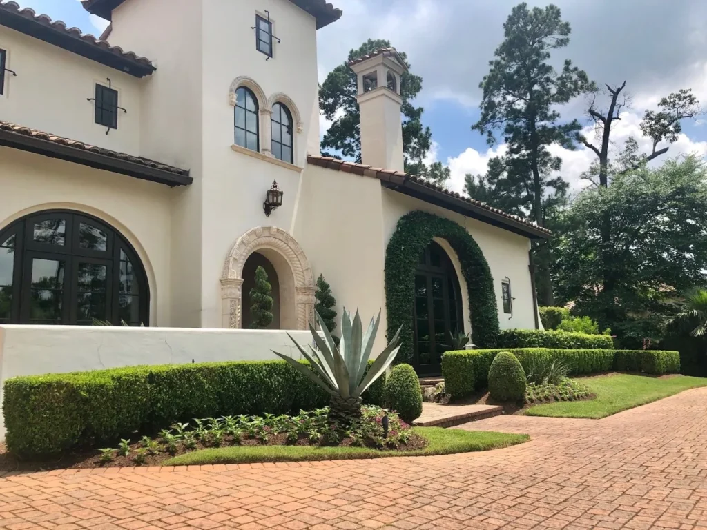 Paver driveway and professionally installed landscaping at a luxury home