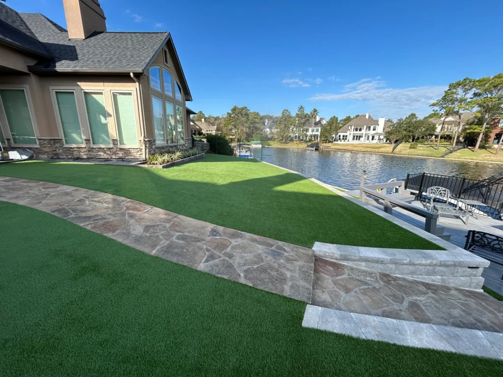 Waterfront retaining wall and graded landscape designed for long-term drainage