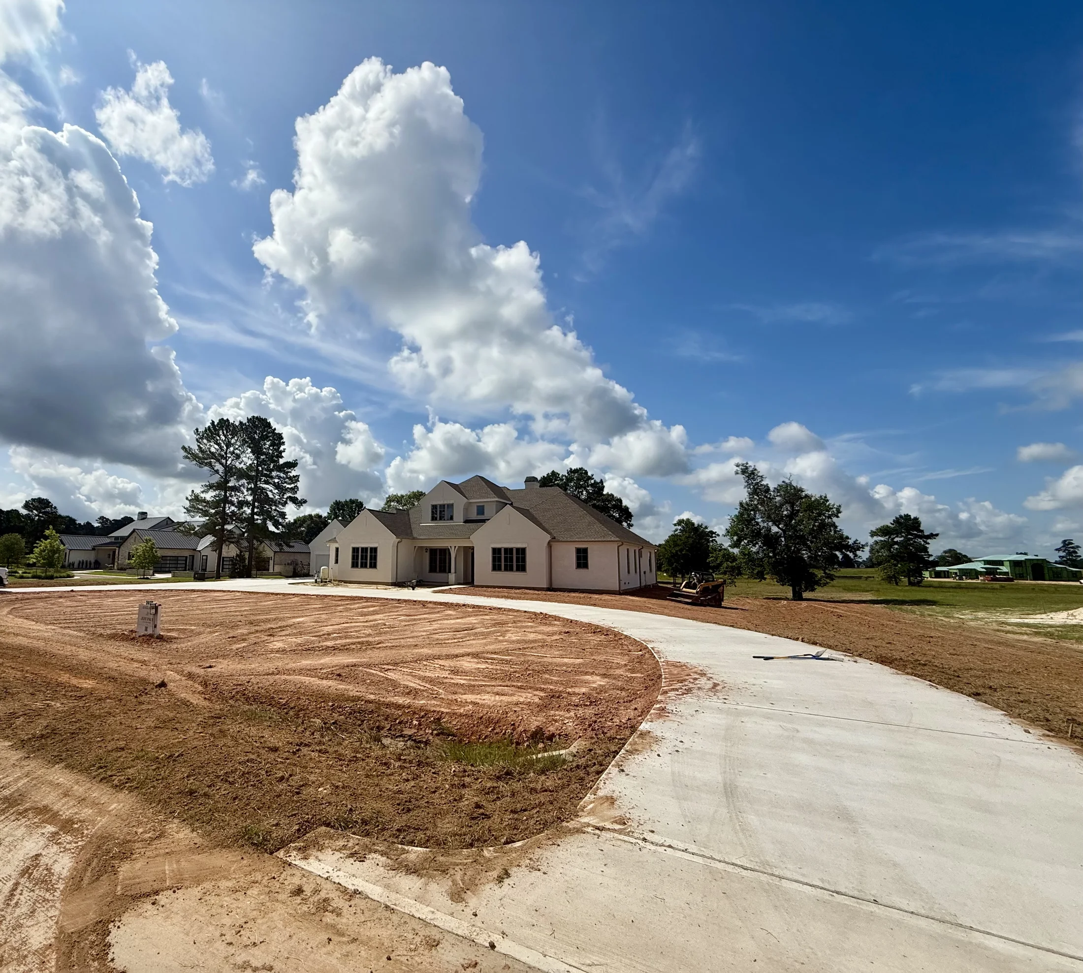 Jeff Paul custom home site before landscaping front driveway view